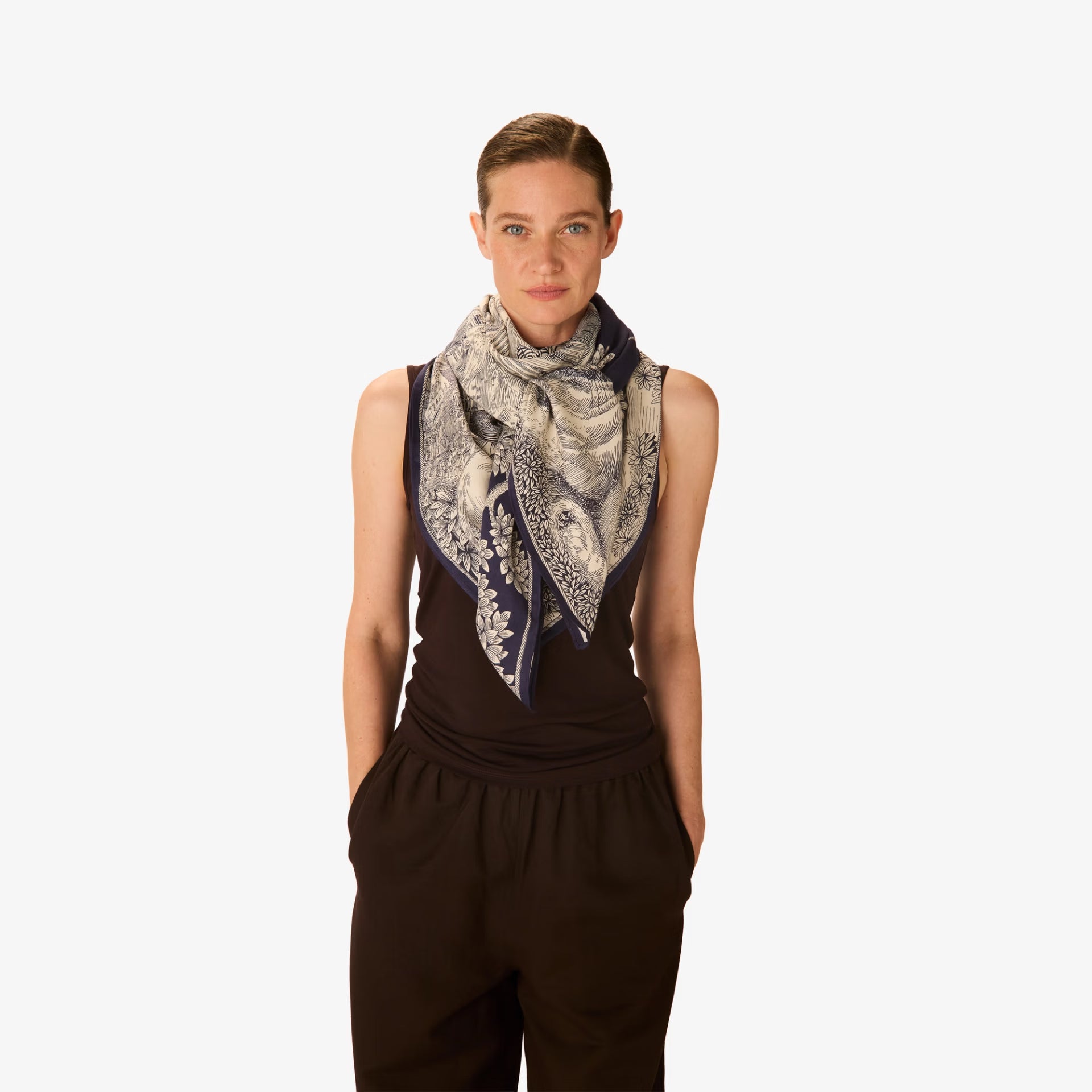 Woman wearing a patterned scarf on a white background