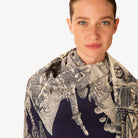 Woman wearing a patterned scarf on a white background