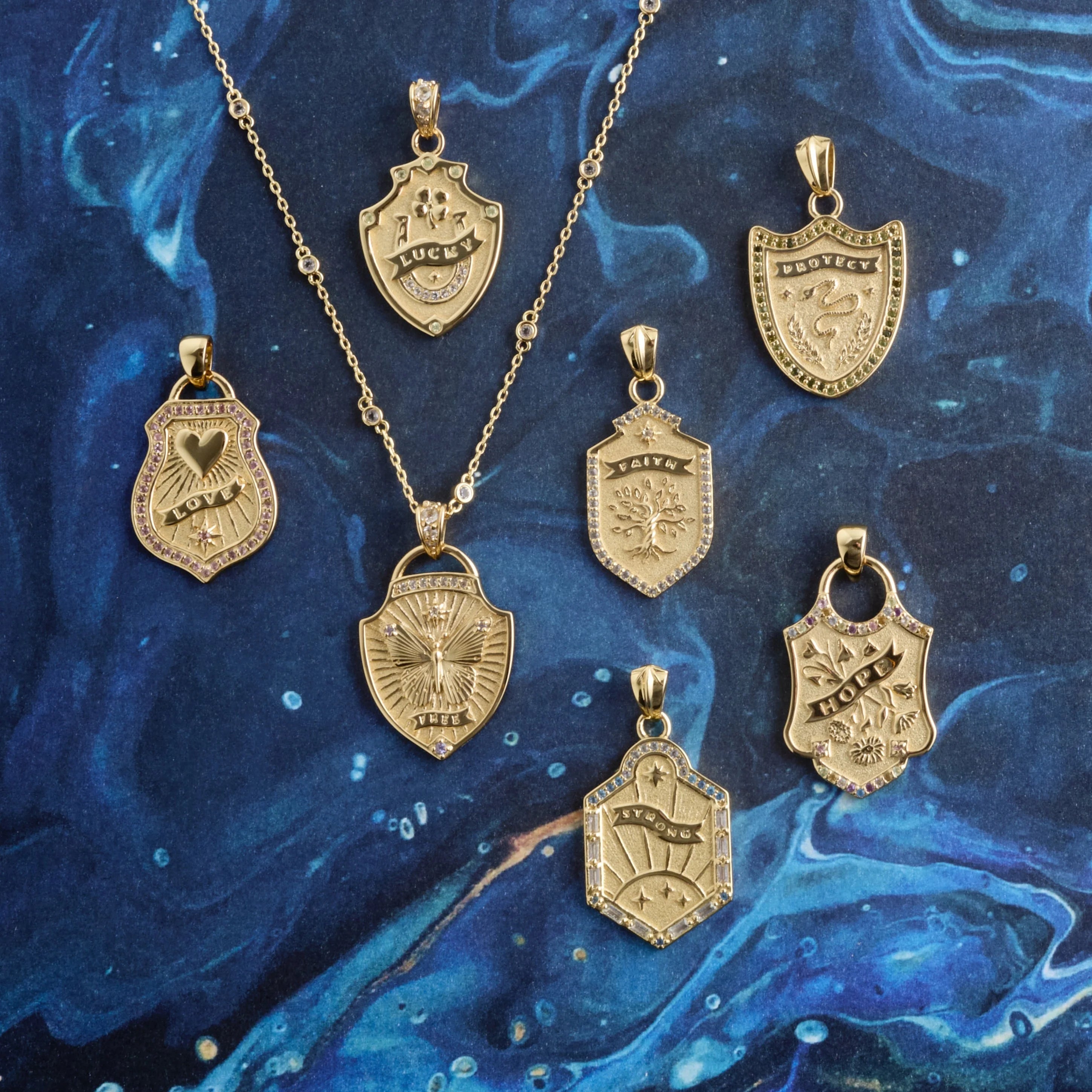 Gold pendants on a blue marbled background