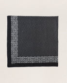 Black and white patterned fabric square on a light beige background