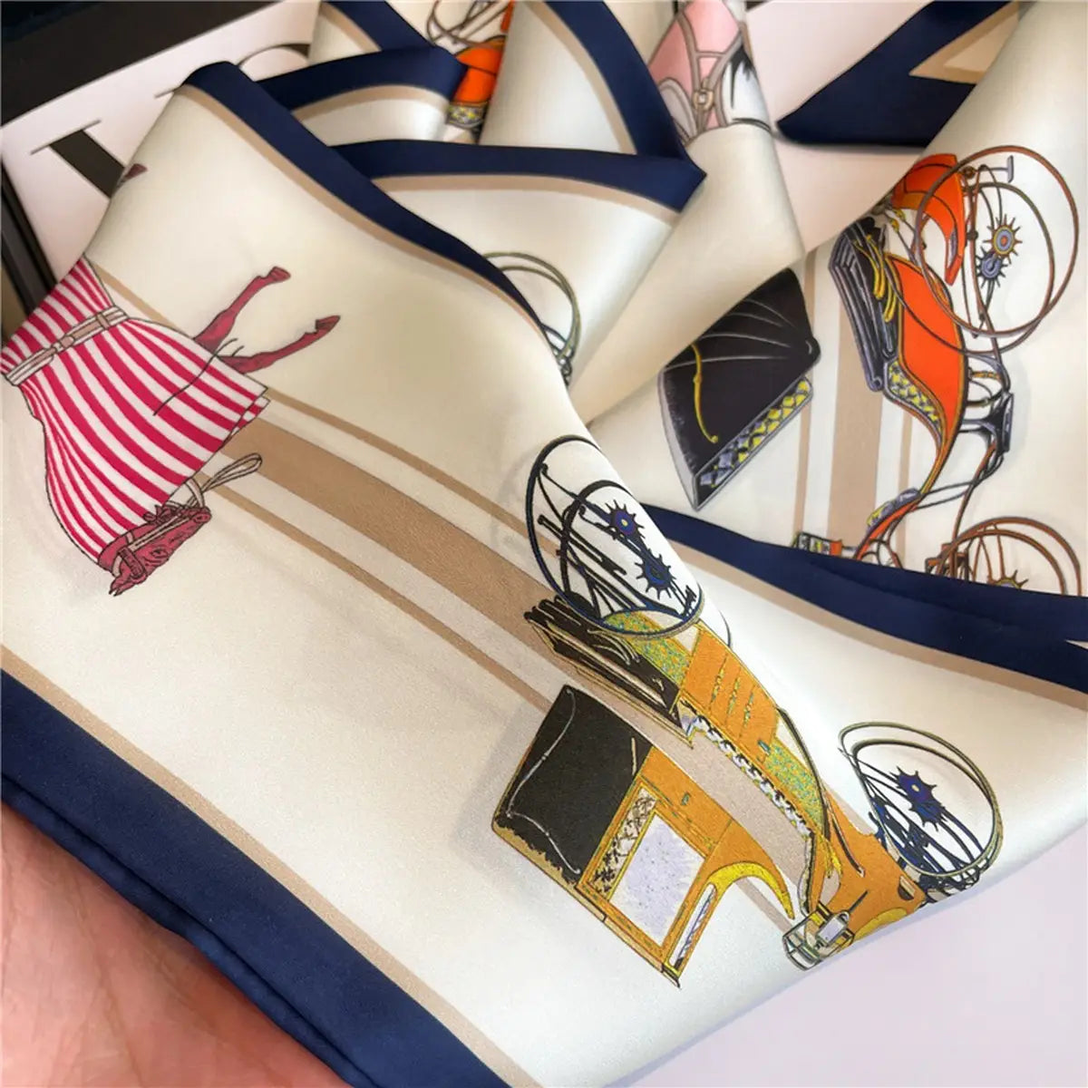 Colorful scarf with vintage car design held by a hand