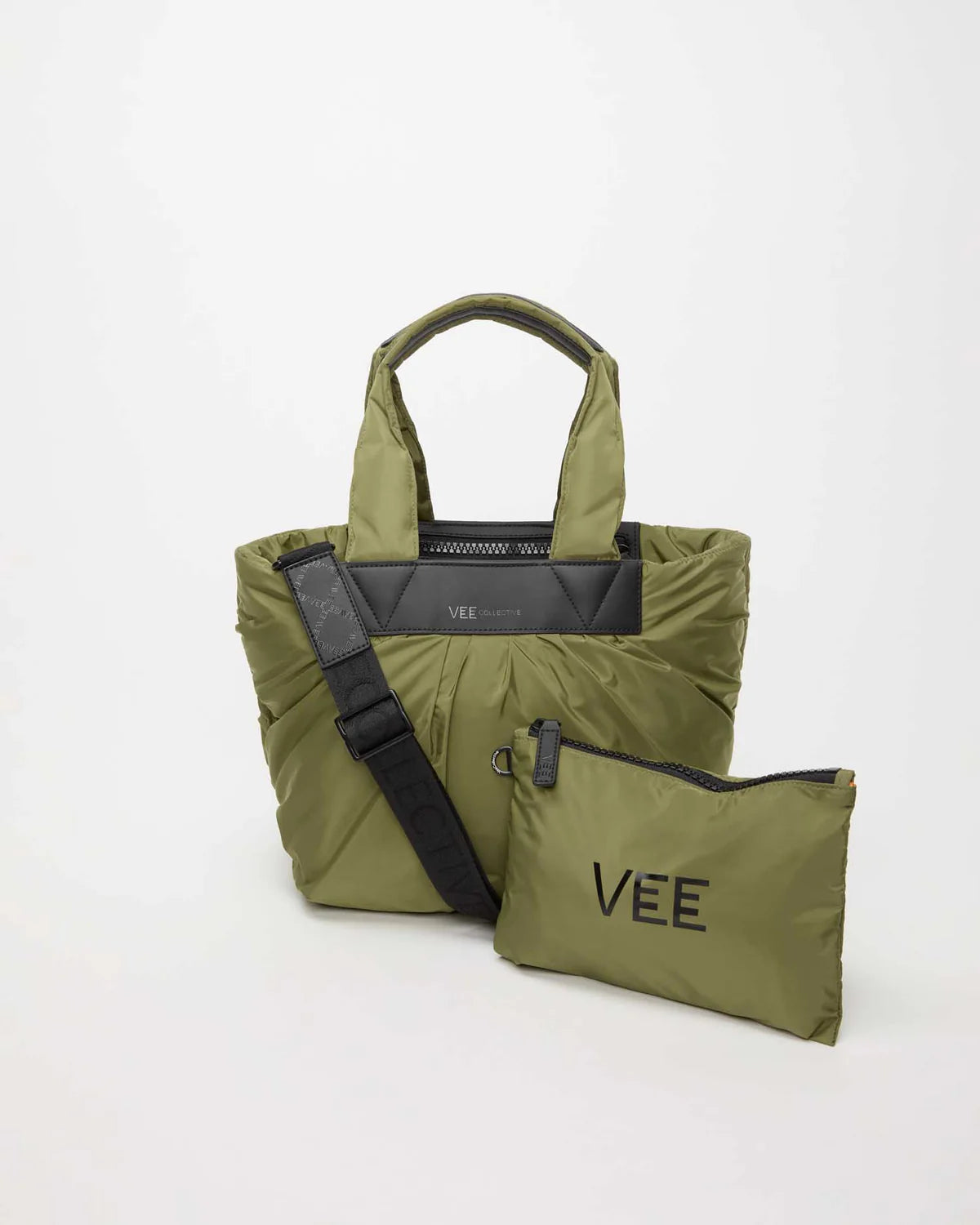 Green tote bag with black strap and 'VEE' branding on a white background