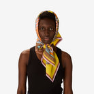 Woman wearing a colorful headscarf on a white background