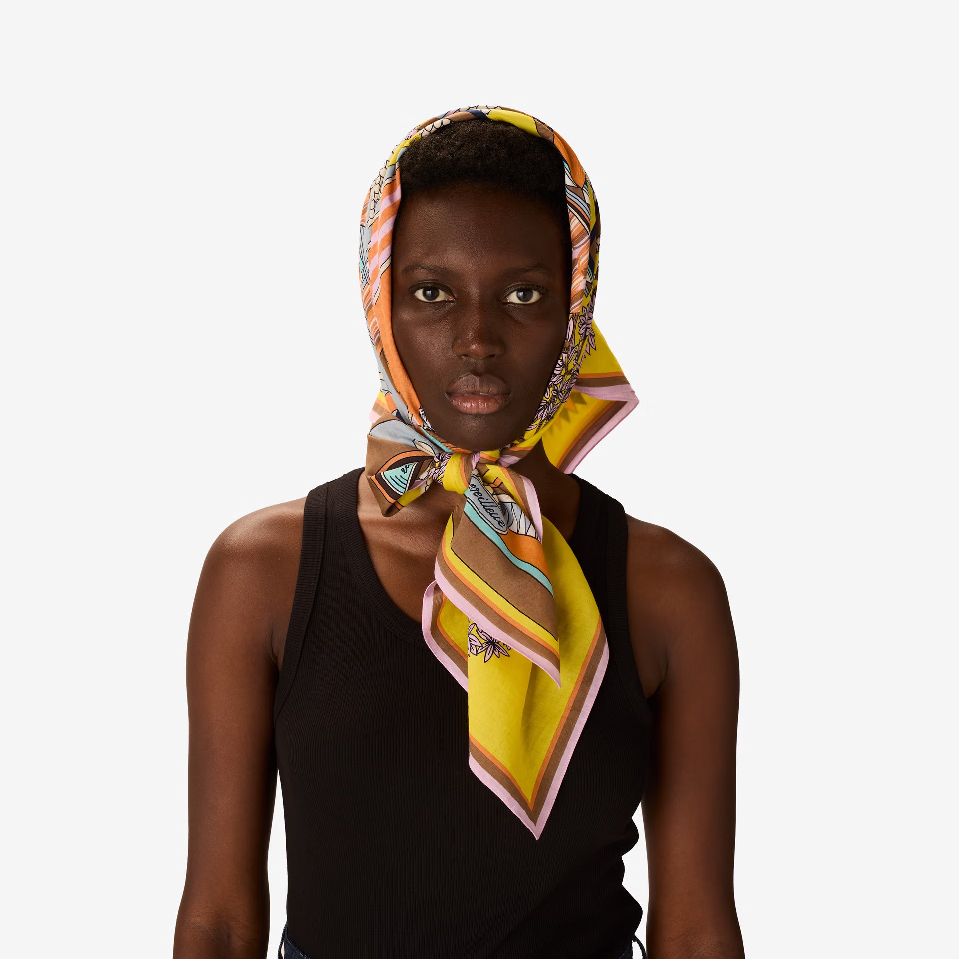 Woman wearing a colorful headscarf on a white background