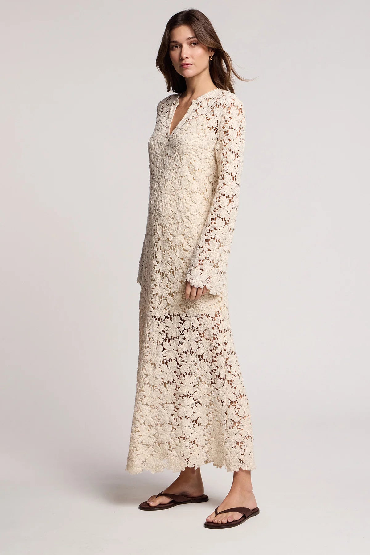 Woman wearing a long floral dress on a white background