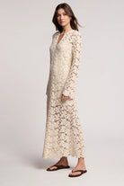 Woman wearing a long floral dress on a white background