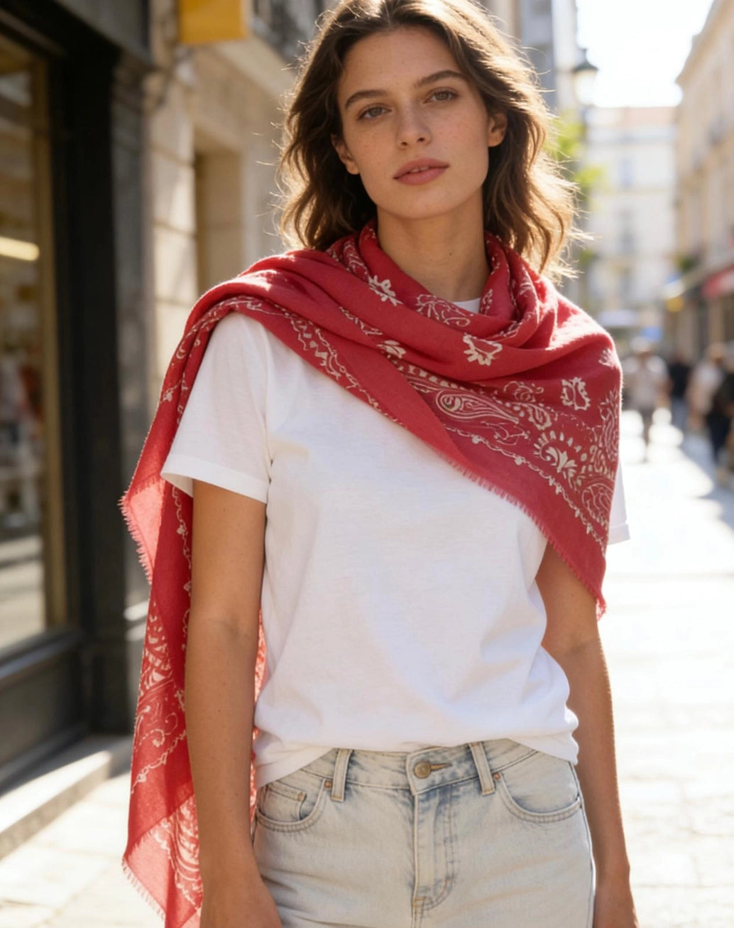 Woman wearing a red patterned scarf on a city street