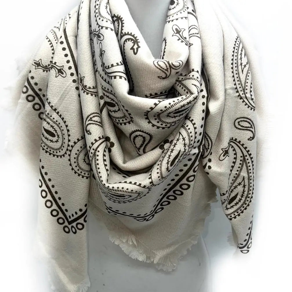 White scarf with black paisley patterns on a white background