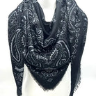 Black paisley patterned scarf on a white mannequin