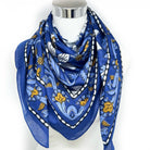 Blue patterned scarf on a mannequin with a white background