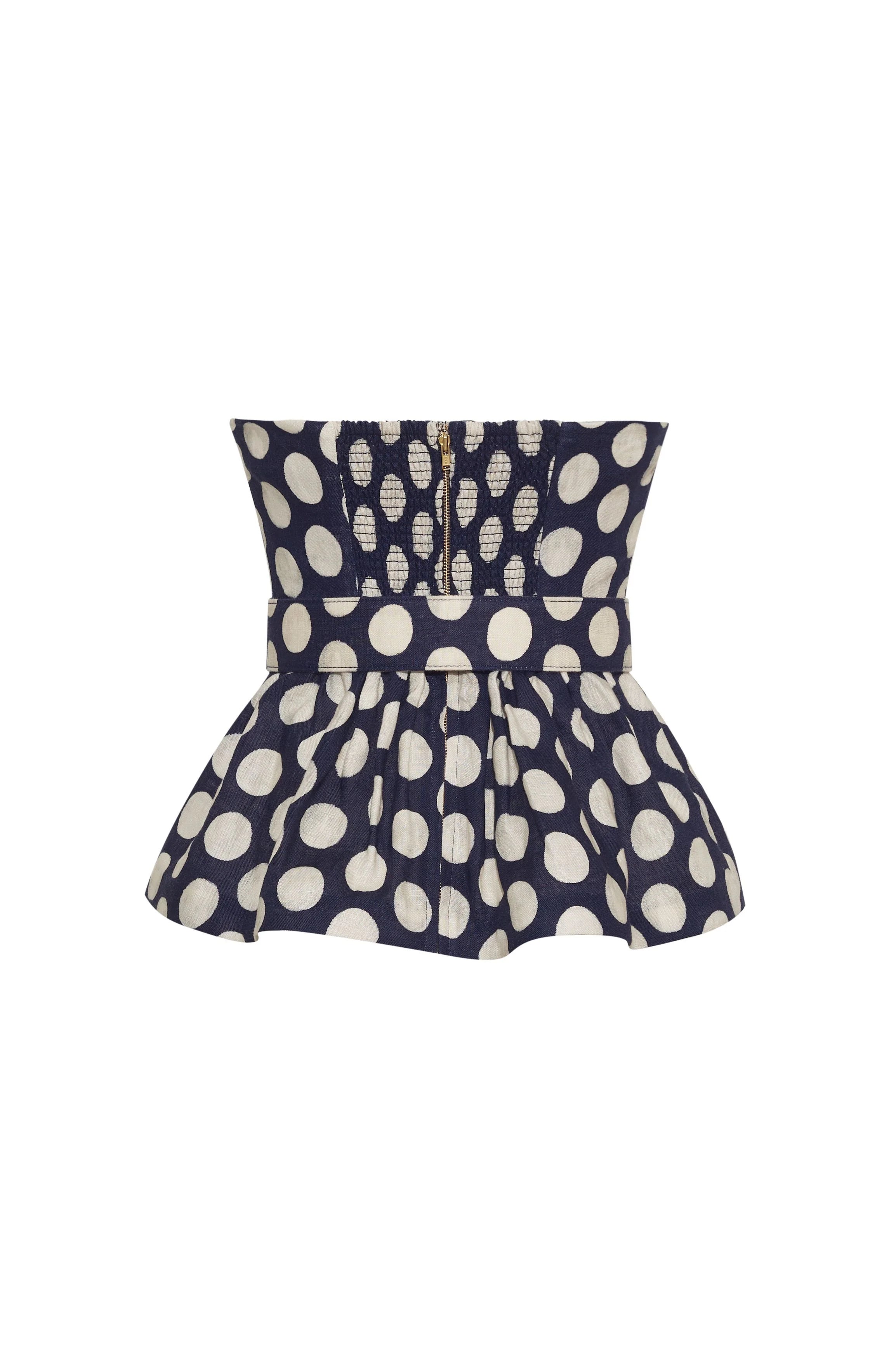 Navy blue top with white polka dot pattern on a white background