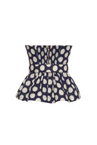 Navy blue top with white polka dot pattern on a white background