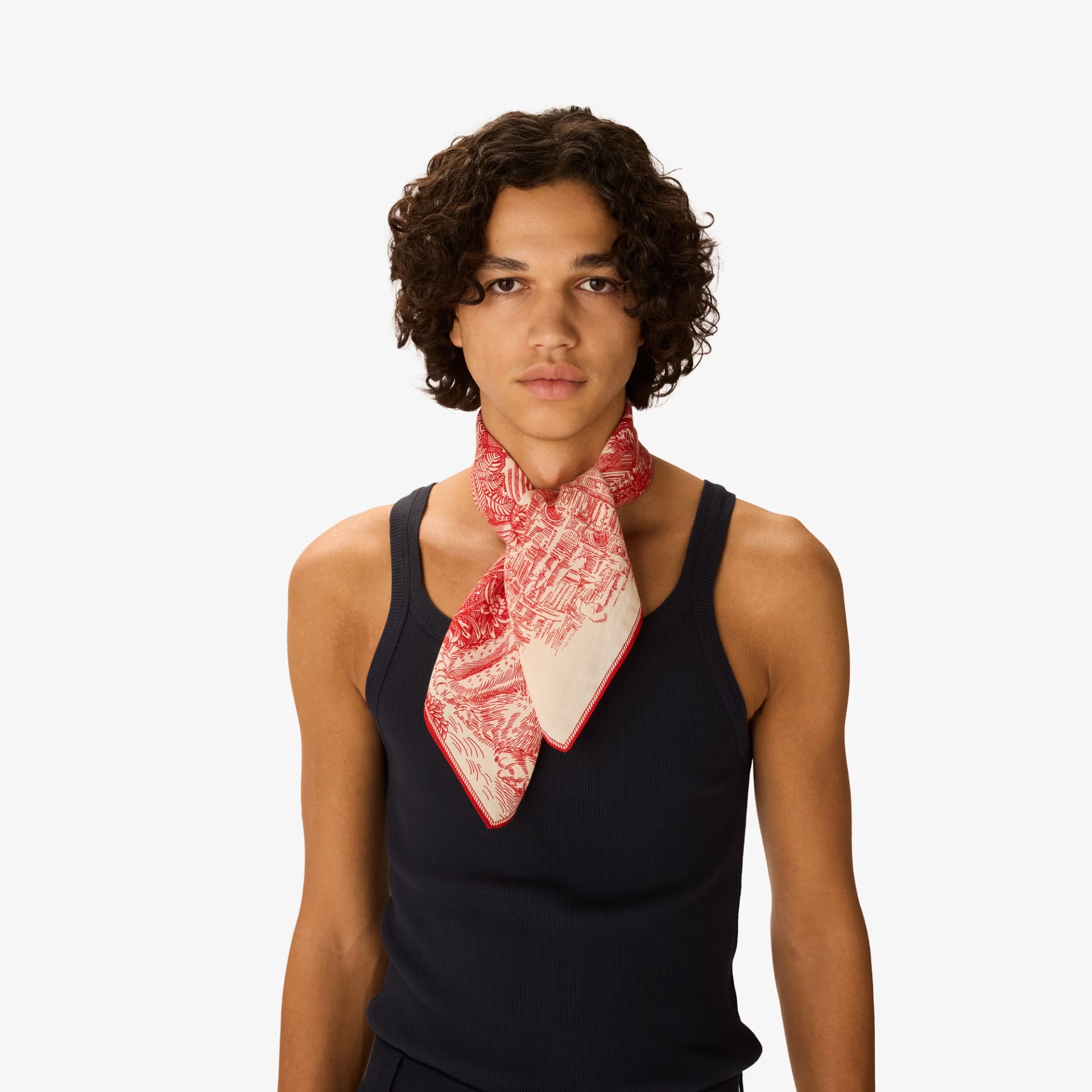 Person wearing a red and white patterned scarf on a white background