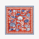 Red scarf with blue and white marine life pattern on a white background