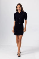 Woman wearing a black outfit on a white background