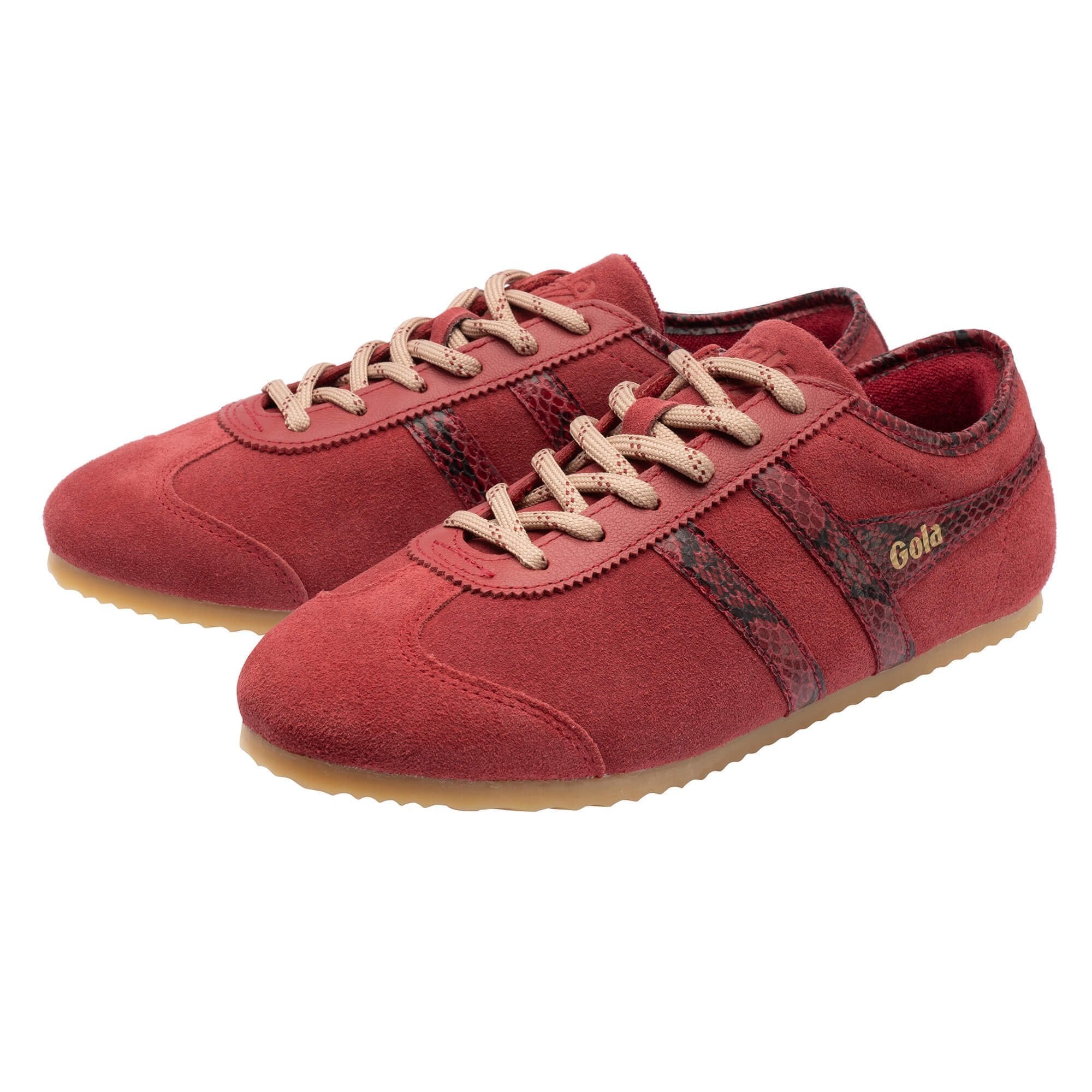A pair of red suede Gazelle sneakers with beige laces, a dark red and black snakeskin pattern stripe on the side, and a beige gum sole, shown on a white background.