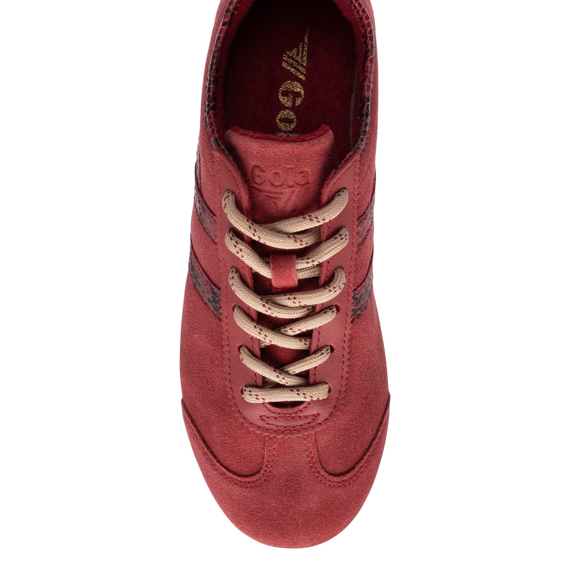A top-down view of a red suede sneaker with beige laces and dark red side stripes, featuring the brand name 'Gorilla' printed on the inner sole.