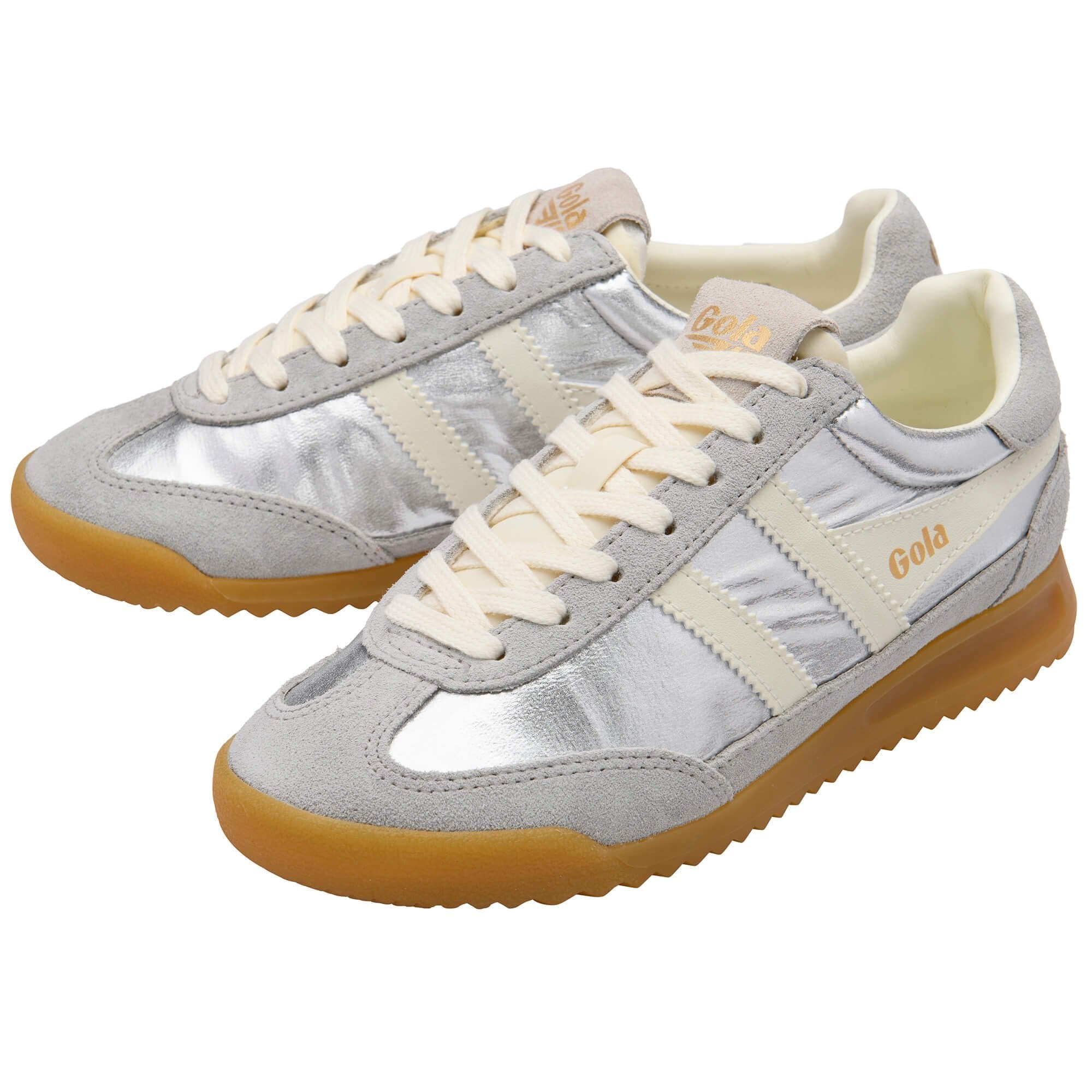 Pair of silver sneakers with white laces and brown soles on a white background