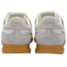 Pair of silver sneakers with white laces and brown soles on a white background