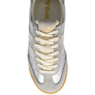 Pair of silver sneakers with white laces and brown soles on a white background