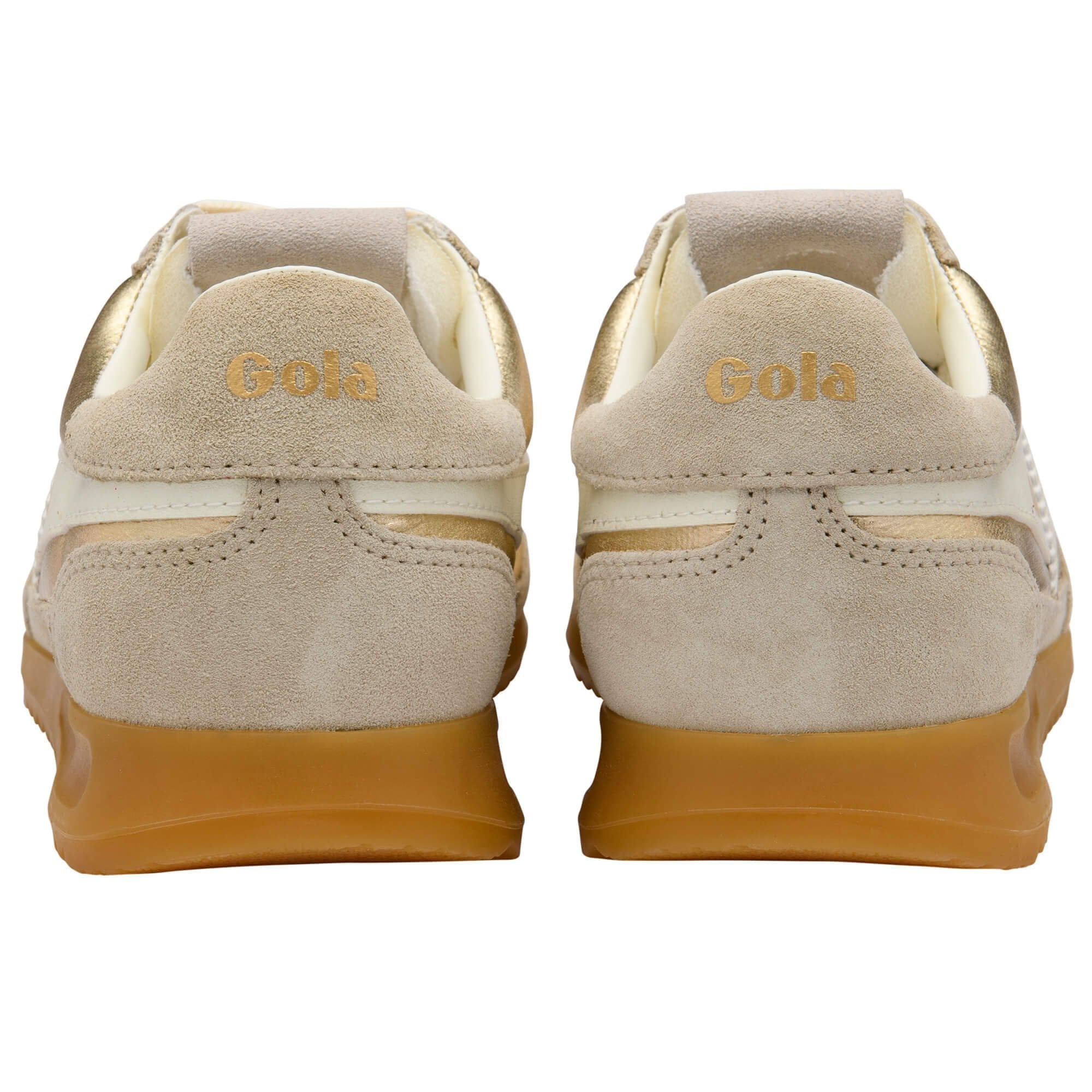 Beige sneakers with gold soles on a white background