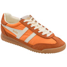 
Orange and brown Adidas sneakers with white stripes on a white background