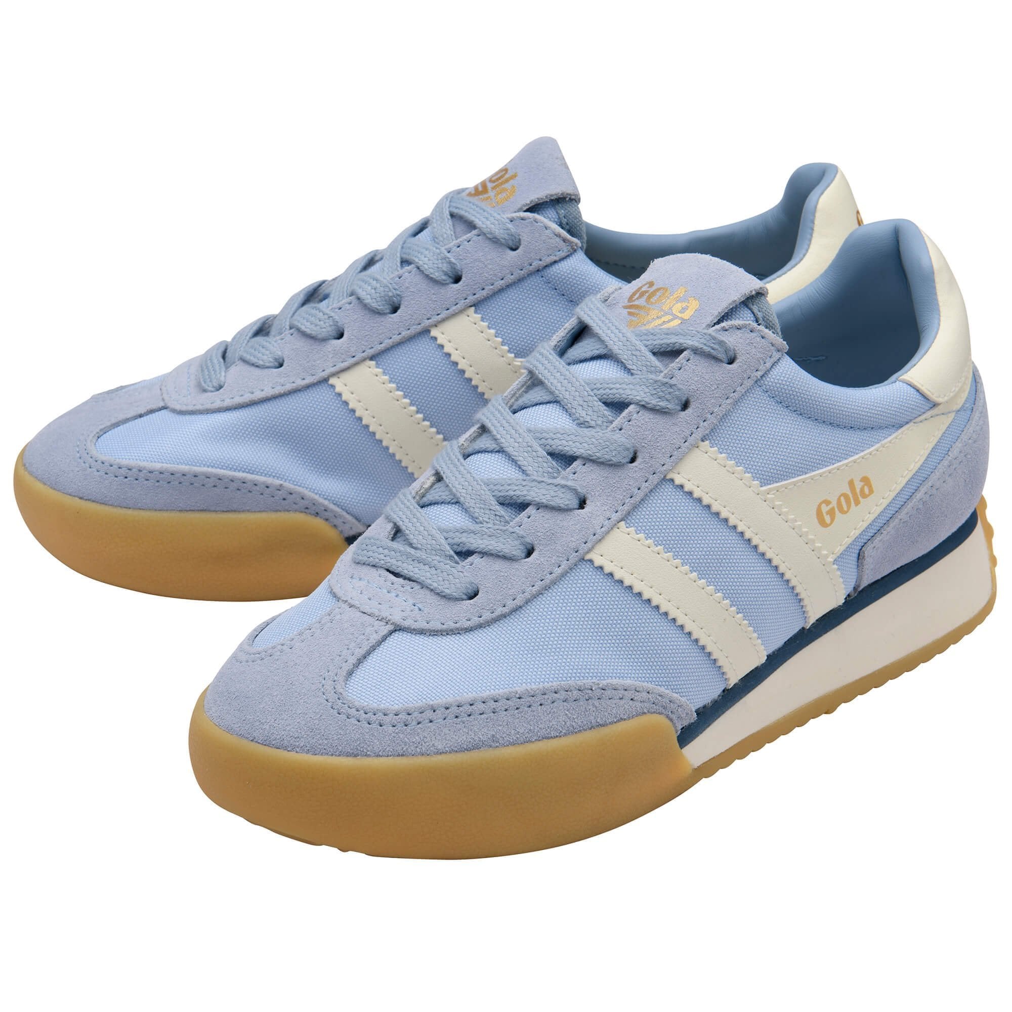 Pair of light blue sneakers with beige soles on a white background