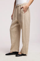 Beige pants worn by a person on a white background