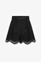 Black shorts with cut-out details on a white background