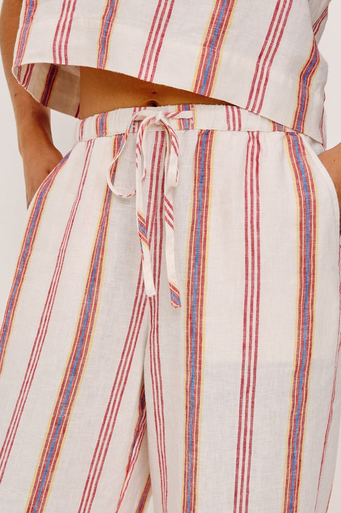 Striped pants with a tie waist on a neutral background