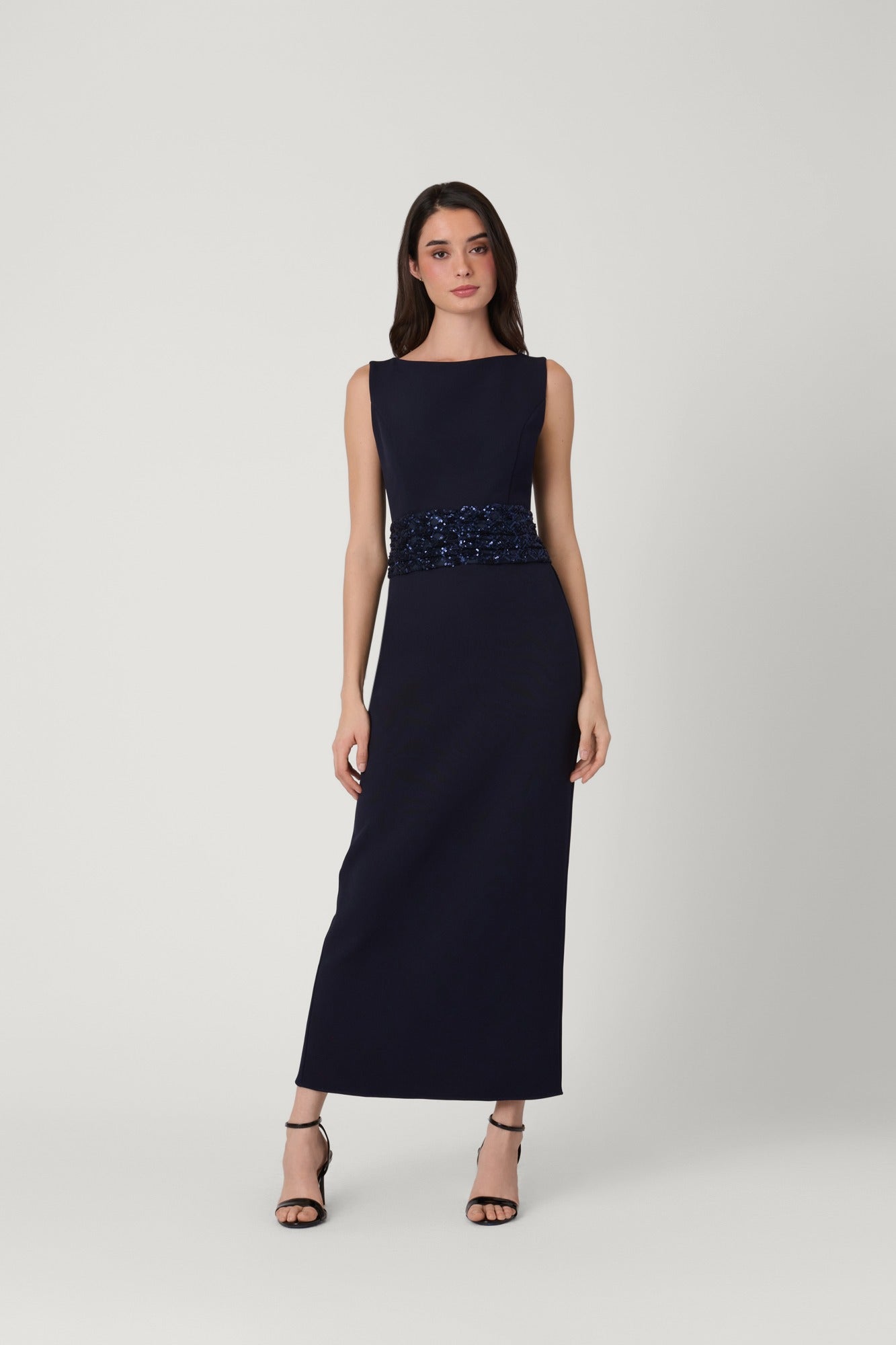 Navy evening gown with beaded waistband on a white background