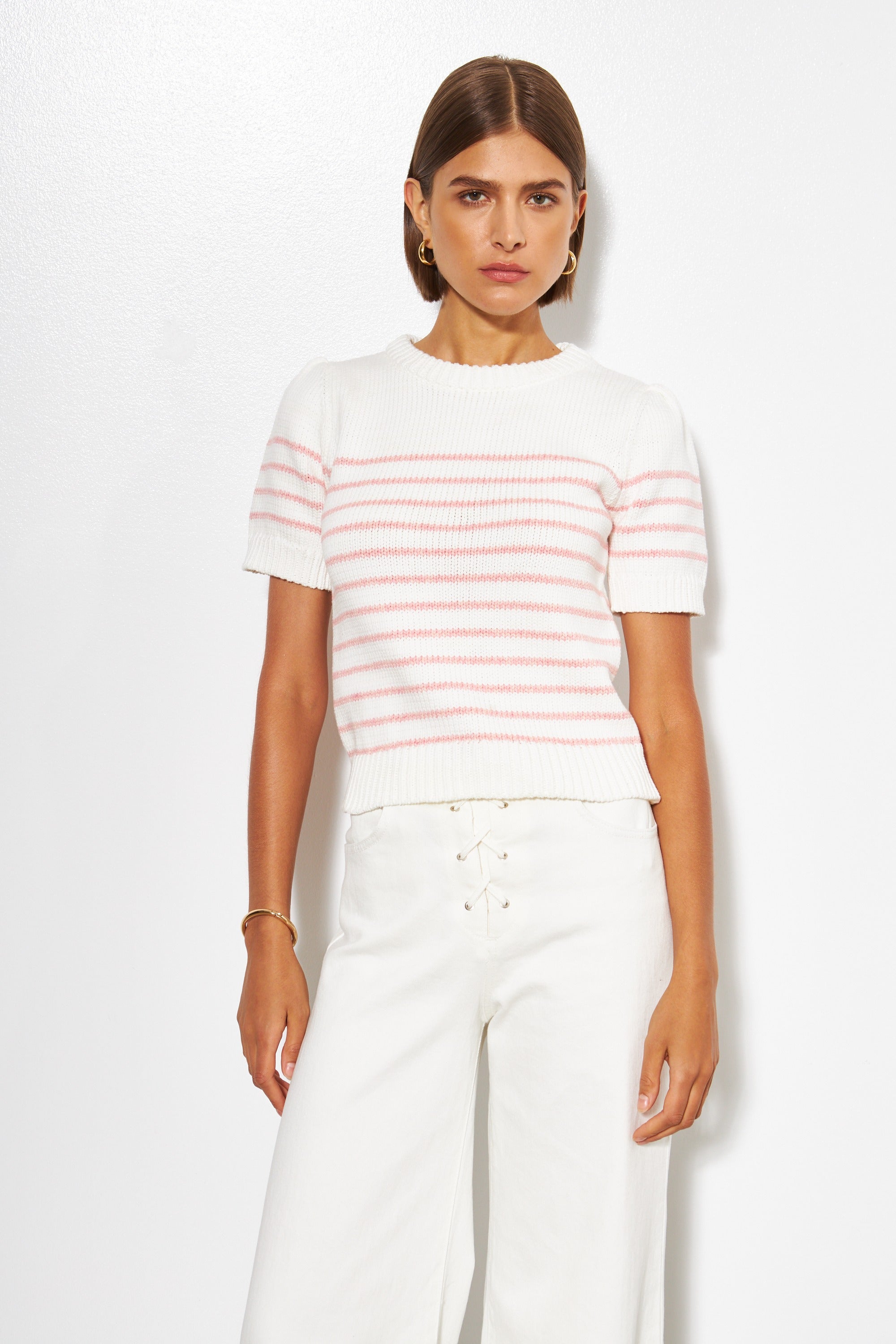 woman wearing a white sweater short sleeve and red stripes with a white background