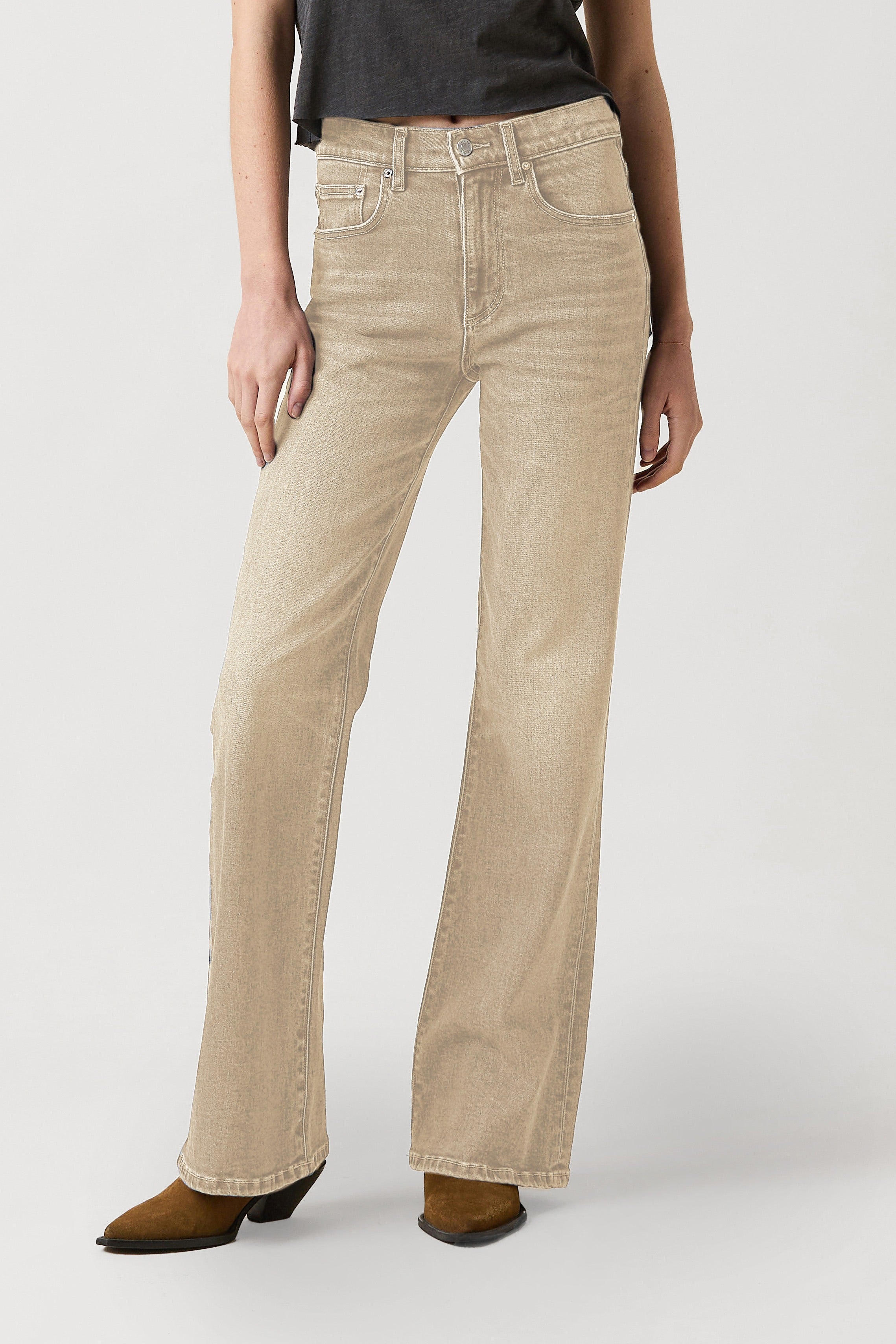 Beige jeans worn by a person on a white background