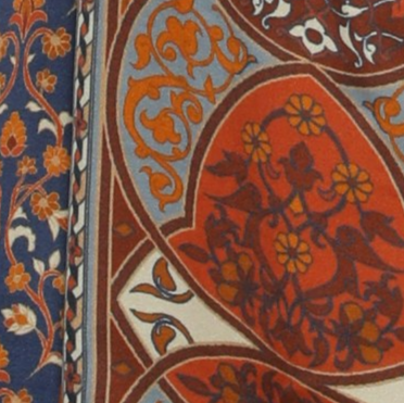 Close-up of a patterned fabric with intricate designs in red, blue, and white.