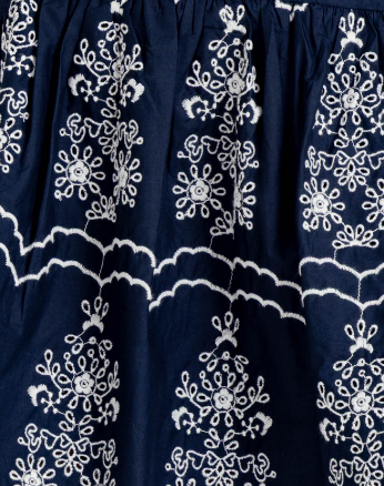 Navy blue fabric with white embroidered patterns