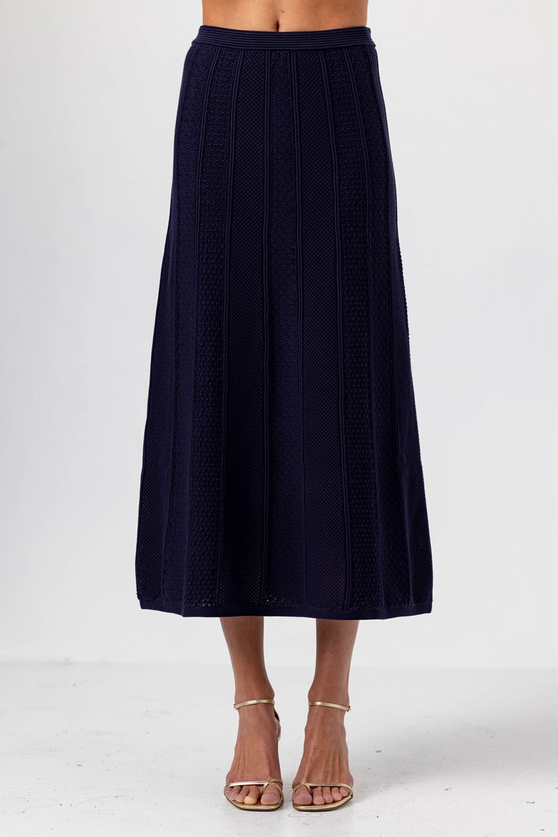 Navy blue skirt worn by a person on a white background