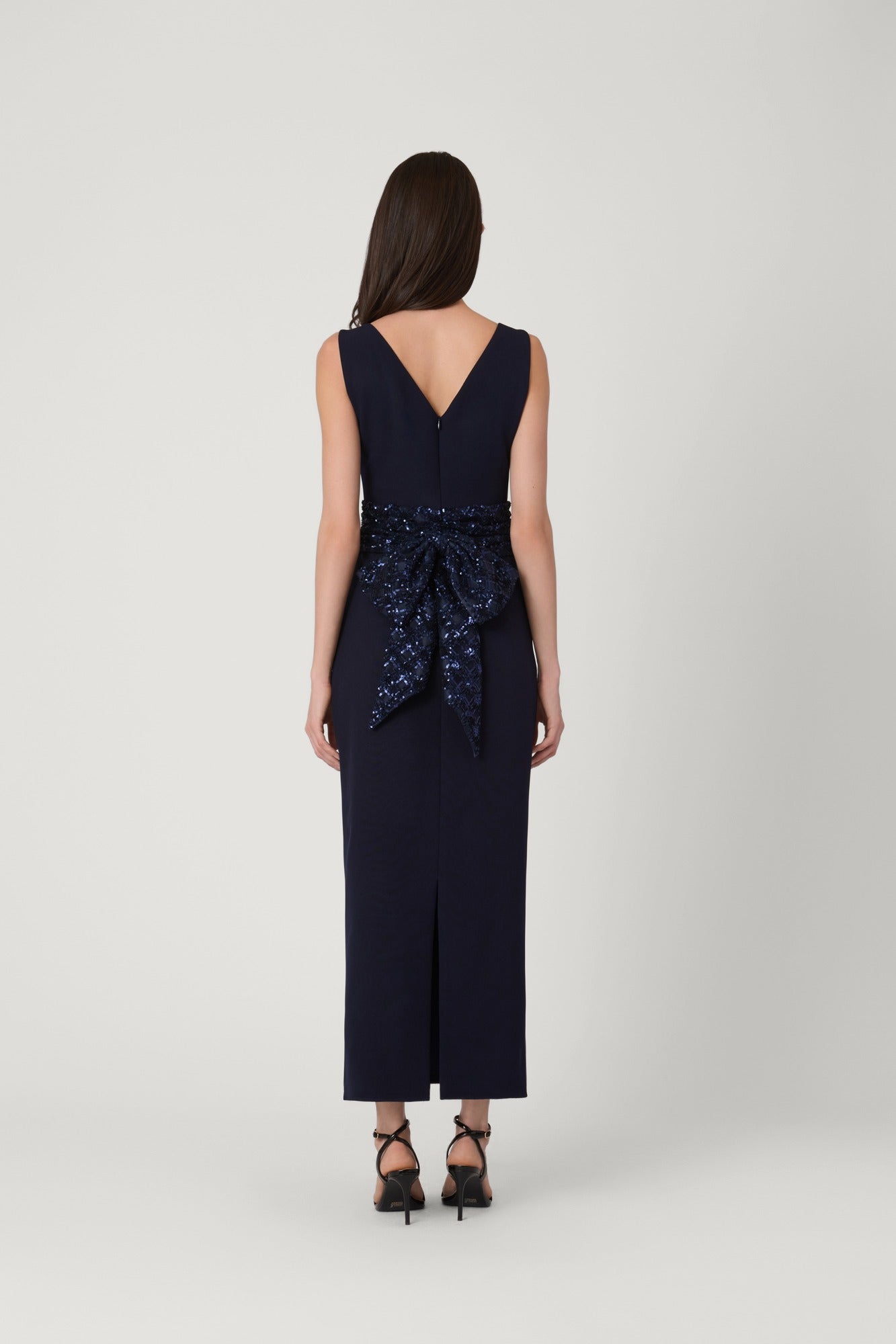 Navy blue dress with a patterned belt on a white background