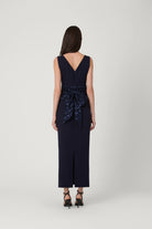 Navy blue dress with a patterned belt on a white background
