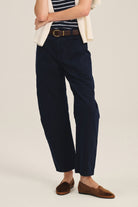 Person wearing navy pants with a white background