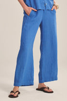 Person wearing blue wide-leg pants on a plain background