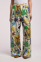 Tropical patterned pants worn by a person on a white background