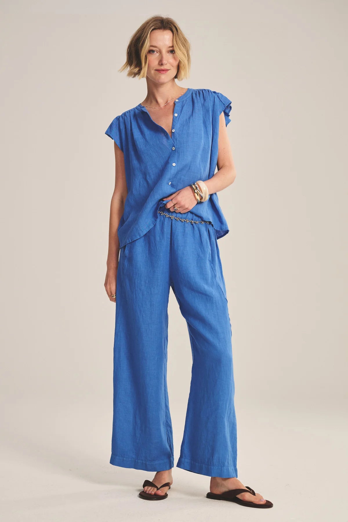 Woman wearing a blue outfit on a plain background