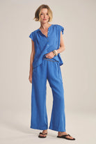 Woman wearing a blue outfit on a plain background
