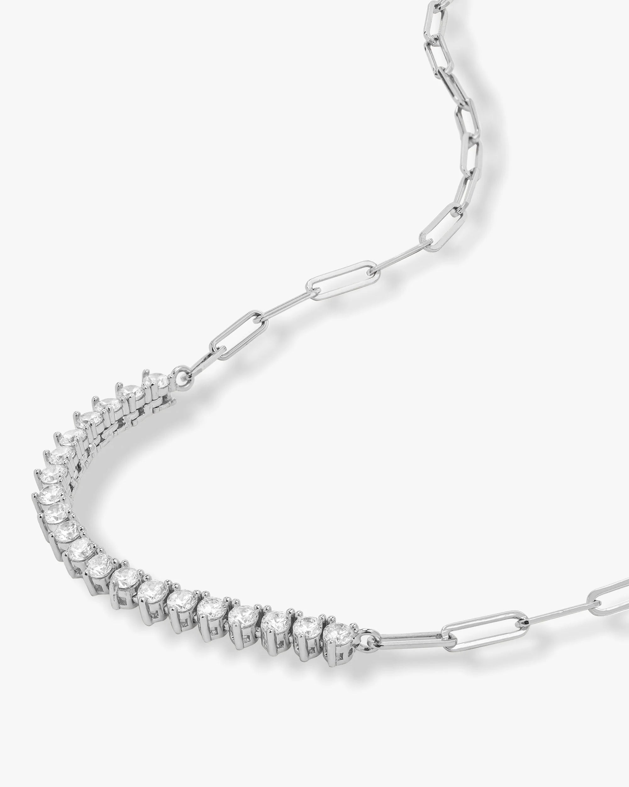 Silver necklace with clear stones on a white background
