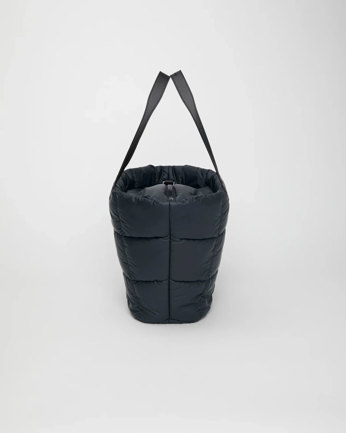 Black puffer bag with a strap on a white background