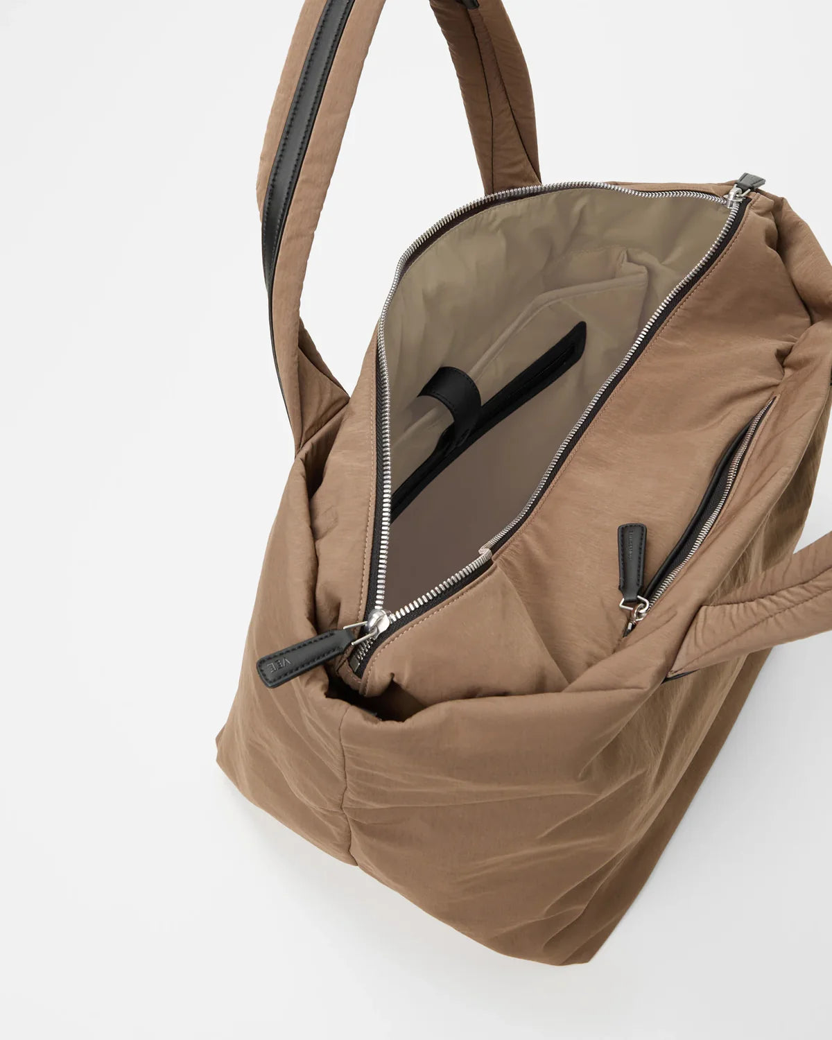 Brown backpack with open front pocket on a white background