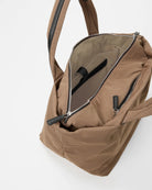 Brown backpack with open front pocket on a white background