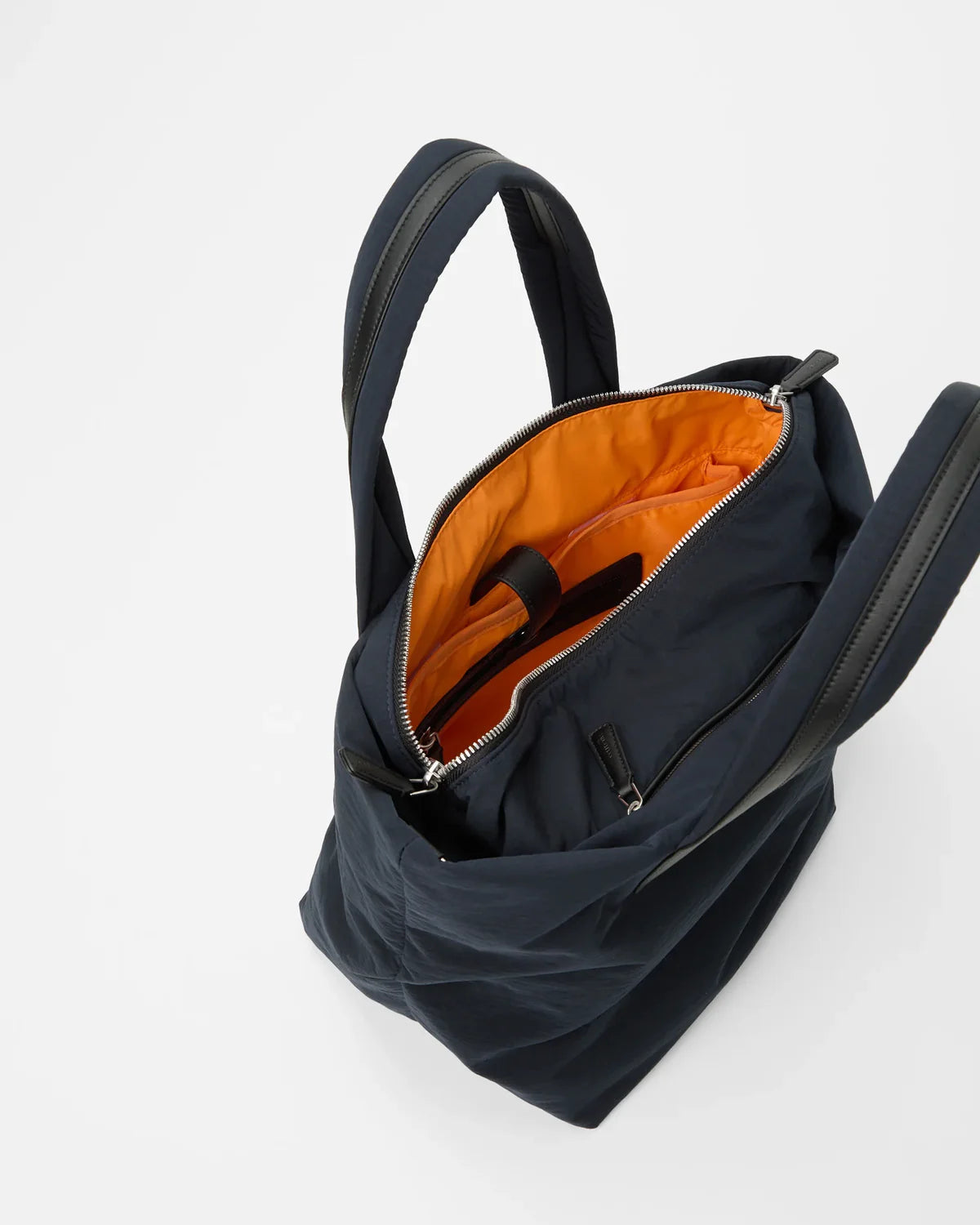 Black backpack with orange interior on a white background