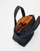 Black backpack with orange interior on a white background
