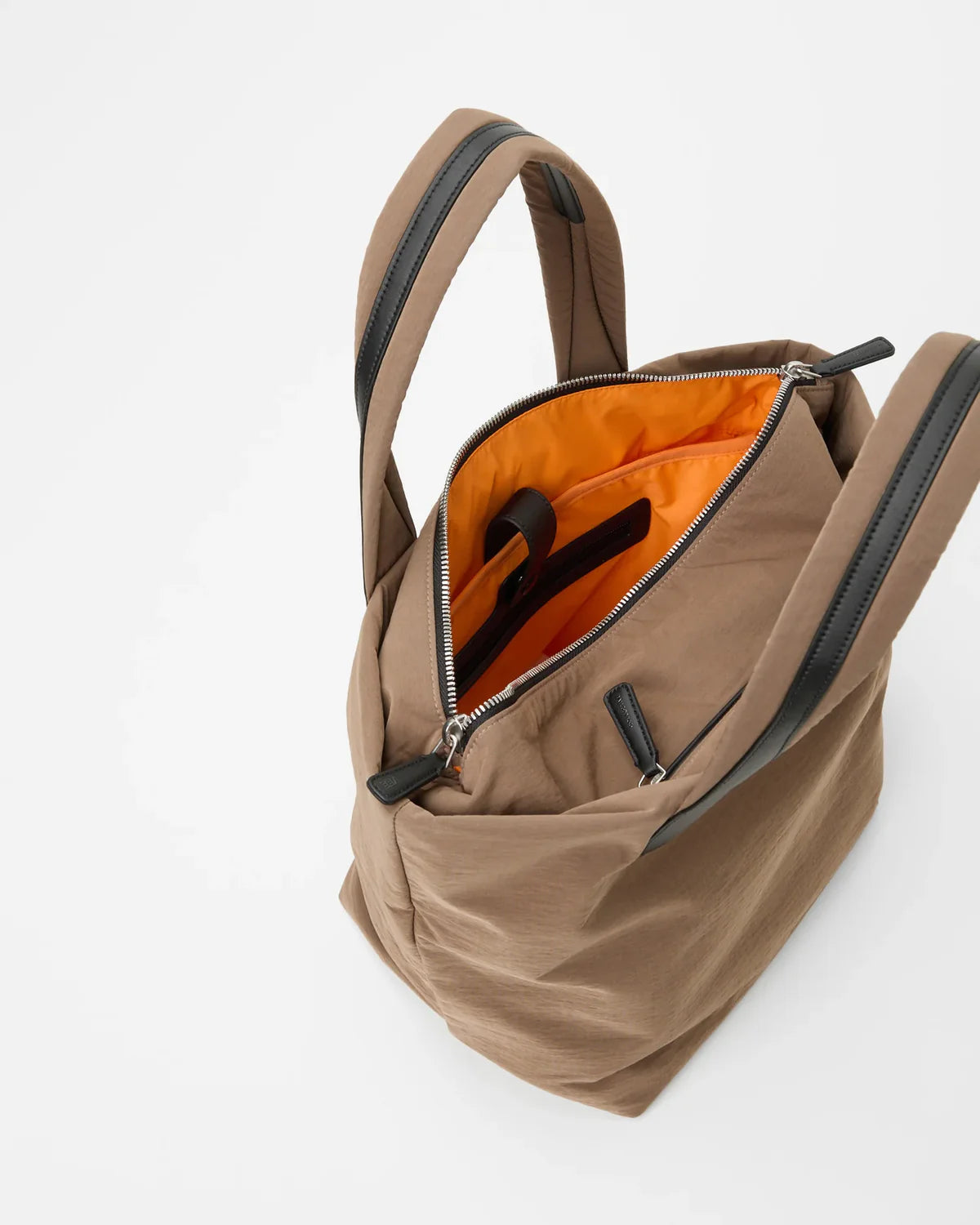 Brown backpack with orange interior on a white background